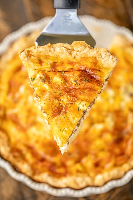 Sausage Biscuit Quiche - our FAVORITE quiche! The crust is made out of homemade biscuit dough. It is like a big open faced sausage, egg and cheese biscuit. SO good!!! Self-Rising flour, butter, buttermilk, sausage, cheese, eggs, half-and-half and sour cream. Great for breakfast, lunch or dinner. Everyone LOVES this yummy casserole!!! #quiche #breakfast #biscuit