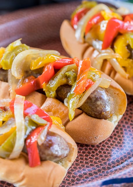 Slow Cooker Beer Brats - perfect tailgating food! Just toss everything in the slow cooker and let it work its magic. Can serve out of the slow cooker too! SO easy and the brats taste amazing!! Brats, beer, onion, bell peppers, salt, pepper, Worcestershire and garlic. A real crowd pleaser!