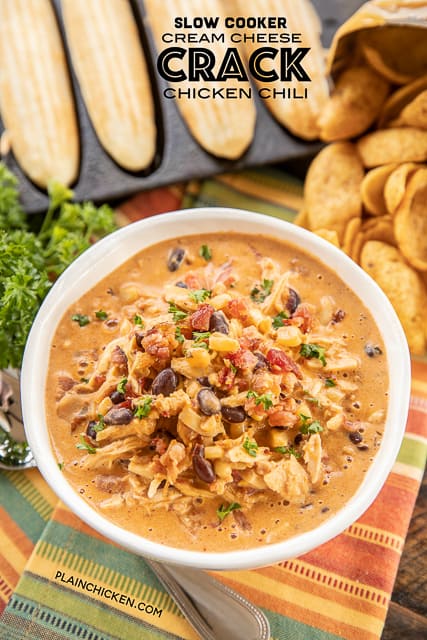 Slow Cooker Cream Cheese Crack Chicken Chili - this stuff is AMAZING! We've made it 3 times this month! We can't get enough of it!!! Chicken, corn, black beans, chicken broth, diced tomatoes and green chiles, cumin, chili powder, onion, ranch seasoning, bacon and cheddar cheese. We served the chili with some cornbread and Fritos. PERFECT! This is already on the menu again this weekend! YUM! #crockpot #slowcooker #chicken #chili