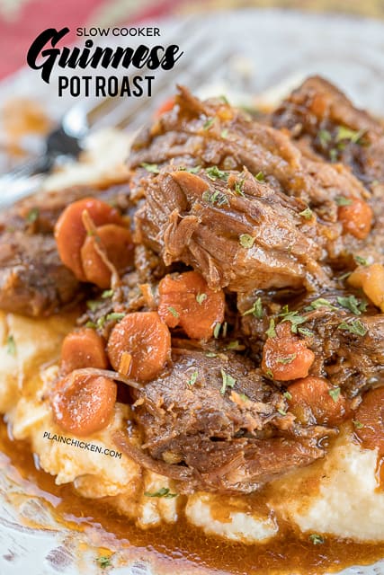 Slow Cooker Guinness Pot Roast - the BEST pot roast EVER! Pot roast, gravy mix, Italian dressing mix, tomato paste, carrots and potatoes. Put everything in the slow cooker and let it cook all day. Serve over mashed potatoes, grits or rice. PERFECT for St. Patrick's Day!! #slowcooker #stpatricksday #potroast