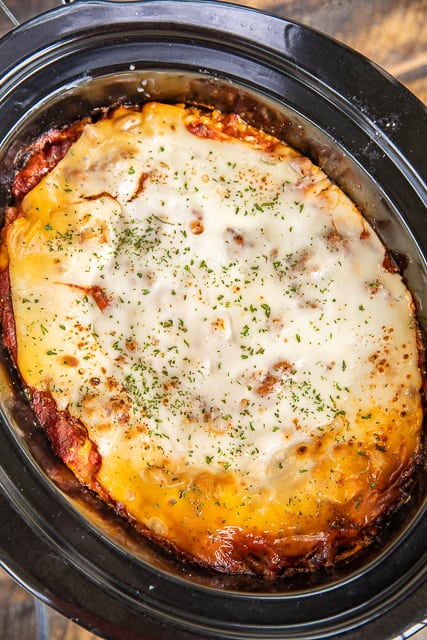Slow Cooker Lasagna - our favorite lasagna recipe made in the slow cooker! SO easy! No need to boil the noodles - just toss them in the slow cooker unbaked.They will cook along with the lasagna in the slow cooker. Italian sausage, cottage cheese, egg, parsley, spaghetti sauce, tomato sauce, lasagna noodles, mozzarella and parmesan. Serve with some garlic bread and a salad. Can freeze leftovers for later. We LOVE this lasagna casserole recipe!!! #crockpot #slowcooker #lasagna