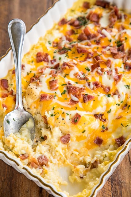 Smothered Chicken and Rice recipe - seriously delicious! Everyone cleaned their plate and asked for seconds! That never happens at our house!!! Chicken and rice baked in cream of chicken soup, milk, cheddar, mozzarella and bacon. Ready to bake in a snap and on the table in 30 minutes. We make this at least once a month!! SO GOOD!! #chickenrecipe #easychickenrecipes #chickenandrice #casserolerecipe #30minutedinnerrecipe