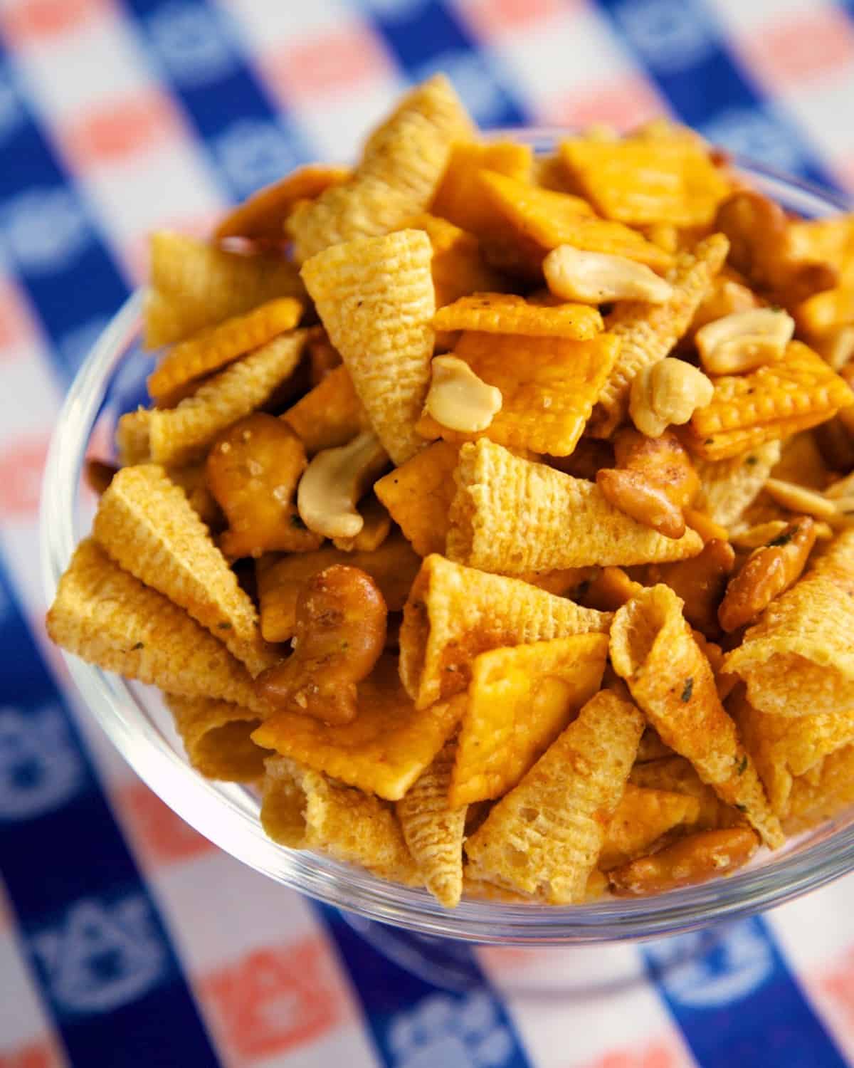 Buffalo Ranch Snack Mix - SO good! I took this to a party and it was the first thing to go. Everybody asked for the recipe!! No baking required! Bugles, Goldfish pretzels, Cheez-its, cashews, ranch dressing mix, buffalo sauce and oil. Toss together and it is ready to eat! #snack #tailgating #nobake #partyfood #appetizer
