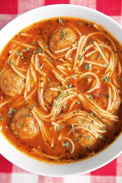 {Slow Cooker} Spaghetti and Meatball Soup recipe - frozen meatballs, spaghetti sauce, beef broth and angel hair pasta - This slow cooker soup is such a fun twist to spaghetti night! It is SO good and super quick to throw together. Serve with some warm garlic bread for a quick and easy weeknight meal!