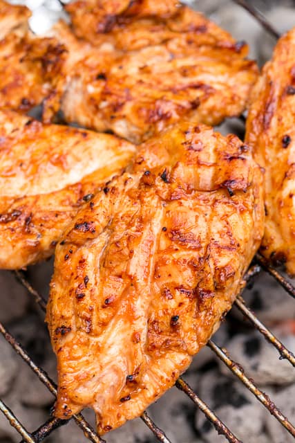 Sriracha Pineapple Grilled Chicken Recipe - chicken marinated in bbq sauce, mustard, Sriracha, honey and pineapple juice. Sweet, smokey and a tad bit spicy. SO good! Tons of great flavor and super juicy. We doubled the recipe for leftovers.