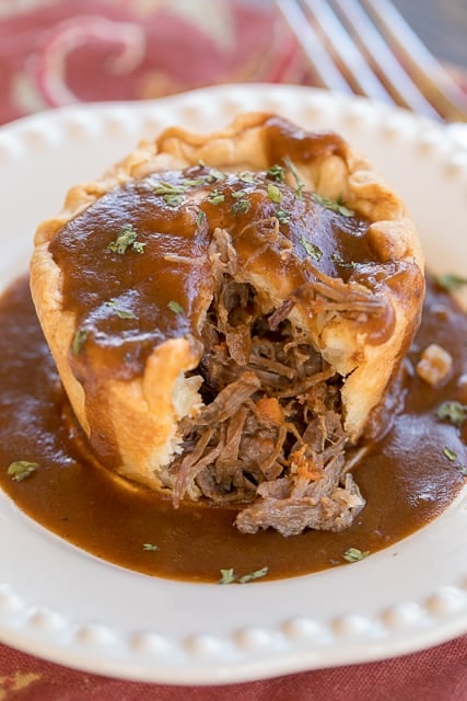 Steak & Ale Pies - Guinness pot roast baked in pie crust. Inspired by our trip to London, England. These taste better than any of the meat pies we ate in the London pubs. YUM! Slow cooked pot roast, pie crust and Guinness gravy. Can make ahead and freeze for a quick meal later! #london #guinness #steak #meatpie