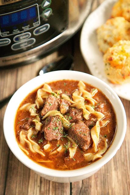 Slow Cooker Steak Soup - sirloin roast, beef broth, onion soup mix, tomato paste, Worcestershire sauce and egg noodles. Cooks all day in the crockpot - even the noodles. Serve with some crusty bread for an easy weeknight meal!