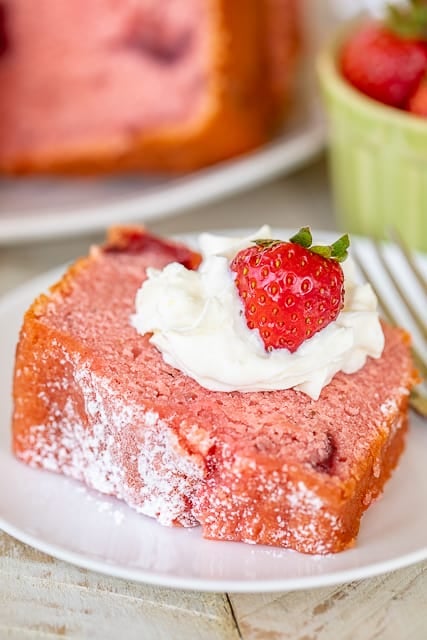 Strawberry Pound Cake - THE BEST strawberry pound cake I've ever eaten! Packed FULL of delicious strawberry flavor! Flour, baking powder, salt, eggs, milk, vanilla, butter, sugar, strawberry jello, frozen strawberries in sugar. Top with whipped cream, vanilla ice cream and fresh strawberries. Can freeze for a quick dessert later. Great for potlucks! #strawberry #poundcake #dessert #cake