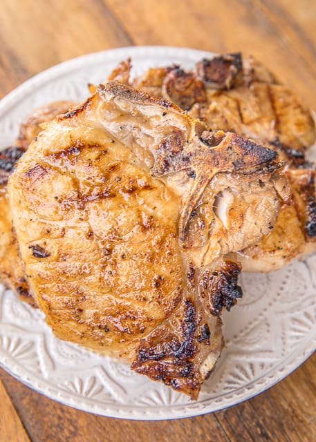 Sweet and Tangy Grilled Pork Chops Recipe - pork chops marinated in cider vinegar, dijon mustard, garlic, lemon juice, lime juice, salt, pepper and brown sugar. THE BEST! We make this at least twice a month!! Can let the pork chops marinate all night in the refrigerator. They are better the longer they marinate. These are our all-time favorite pork chops! #grilling #pork #porkchops #grill
