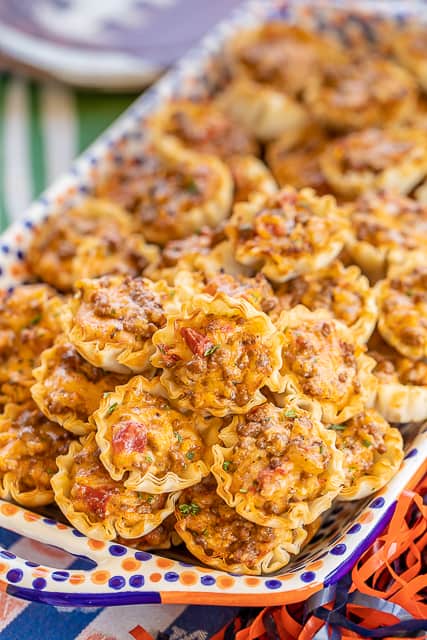 Taco Ranch Bites - seriously delicious!! Only 6 ingredients! Ground beef, taco seasoning, diced tomatoes and green chiles, cheddar cheese, ranch dressing and phyllo tart shells. Can make ahead and refrigerate or freeze for later. I always have a batch in the freezer for a quick snack! Great for tailgating and parties! I never come home with leftovers. Everyone LOVES these cheesy taco bites.