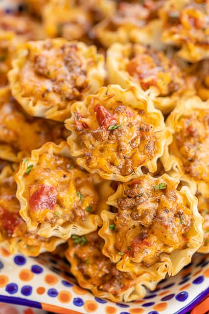 Taco Ranch Bites - seriously delicious!! Only 6 ingredients! Ground beef, taco seasoning, diced tomatoes and green chiles, cheddar cheese, ranch dressing and phyllo tart shells. Can make ahead and refrigerate or freeze for later. I always have a batch in the freezer for a quick snack! Great for tailgating and parties! I never come home with leftovers. Everyone LOVES these cheesy taco bites. #tailgating #taco #beef #ranch #appetizer #partyfood #freezermeal