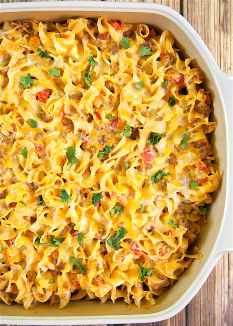 Taco Noodle Bake - SO good!!! Egg noodles, taco meat, cheese, diced tomatoes and green chiles, cheddar cheese soup and sour cream. Everyone cleaned their plate and asked for seconds! Makes a great freezer meal too!! LOVE this easy Mexican casserole!!!