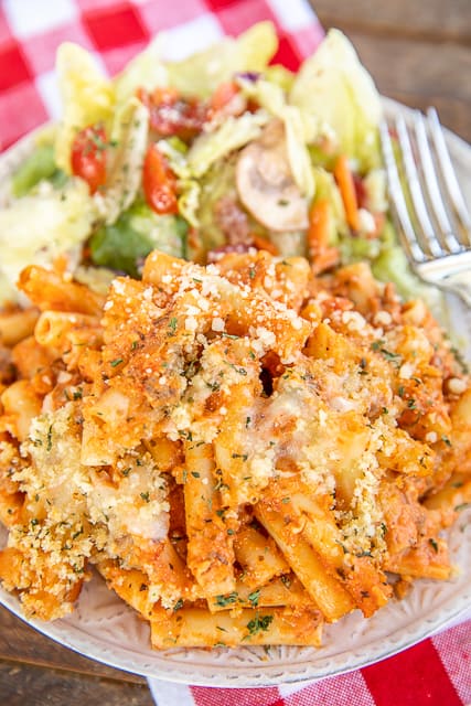 baked ziti and salad on a plate