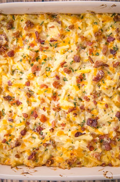 THE ULTIMATE Cracked Out Potatoes - cheddar, bacon and ranch. SO addictive!! I could make a meal out of this potato casserole!! Cheddar, bacon, ranch, cream of chicken soup. sour cream, frozen shredded hash browns. Can freeze for later. We usually bake half and freeze half for later. SO GOOD!