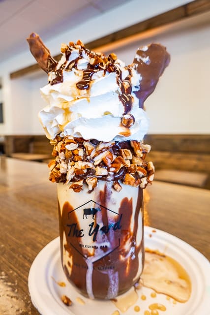 Crazy Shakes from The Yard in Gulf Shores, AL  - 5 Pieyow - Praline pecan ice cream in a chocolate iced jar. Topped with whipped cream, crushed pecans, fudge and maple syrup drizzle, chocolate dipped bacon and a waffle