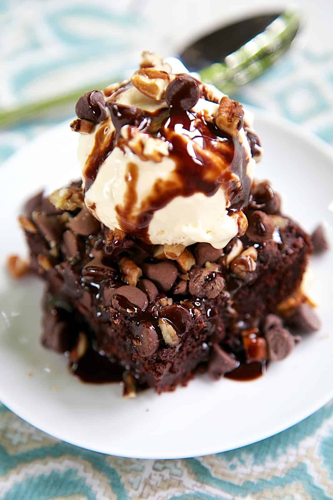 Triple Chocolate Pudding Cake Recipe - only 5 simple ingredients! Pudding, Milk, Cake Mix, Chocolate Chips and Pecans - makes a wonderful fudgy cake! Great topped with ice cream and chocolate sauce.
