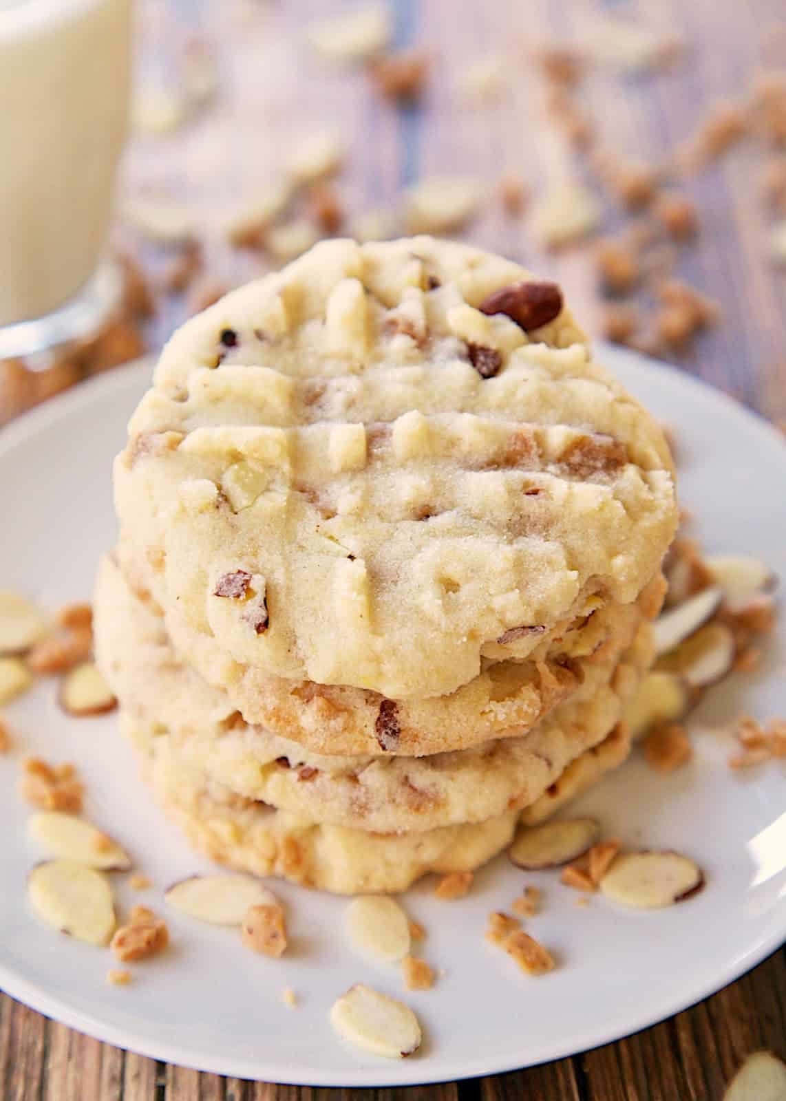 Triple Almond Cookies Recipe - cookies packed with tons of great almond flavor - almond extract, chopped almonds and almond toffee bits! We ate WAY too many of these cookies. Makes a ton. Great for a potluck!
