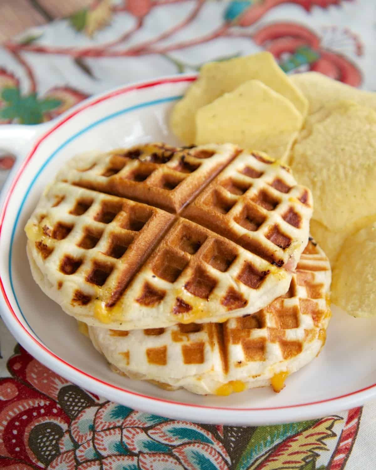 Ham & Cheese Waffle Sandwiches Recipe - ham and cheese stuffed inside a refrigerated biscuit and cooked in the waffle iron. SO much fun to eat!!