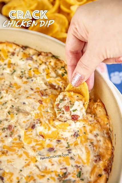 dipping a chip into warm chicken dip