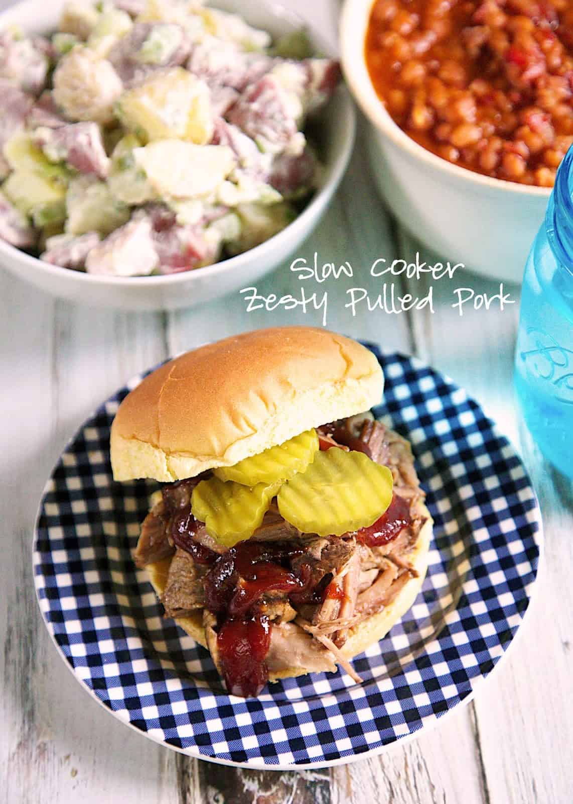 Slow Cooker Zesty Pulled Pork Recipe - pork shoulder slow cooked all day in a mixture of garlic, onion, brown sugar, soy sauce and vinegar - our new go-to slow cooker pulled pork recipe! 