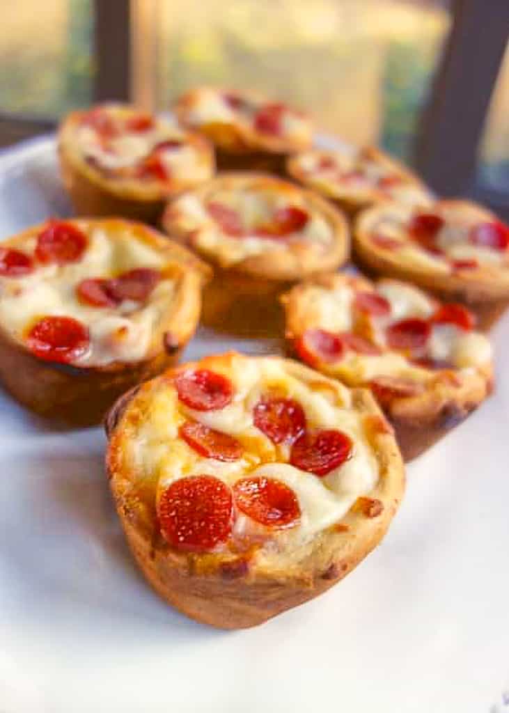 Deep Dish Pizza Cupcakes - make mini deep dish pizzas in your muffin pan! Crescent rolls, pizza sauce, mozzarella cheese. Let the kids customize each pizza with their favorite pizza toppings. Great for tailgating, parties, lunch or dinner. 