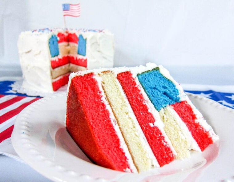 Flag Cake Recipe - transform cake mix into a festive Flag Cake that is perfect for Memorial Day, 4th of July, and Labor Day! It is actually really easy! Bake the cake layers, make a few cuts and assemble. SO impressive and festive!