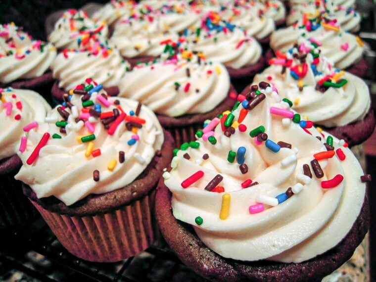 BEST Chocolate Cupcakes & Buttercream Frosting EVER - hands down the BEST cupcakes EVER! Doctor up cake mix and top it with the most delicious buttercream frosting EVER! Everyone in our family requests these cupcakes for their birthday! SO good! #cake #dessert #cupcakes #buttercream