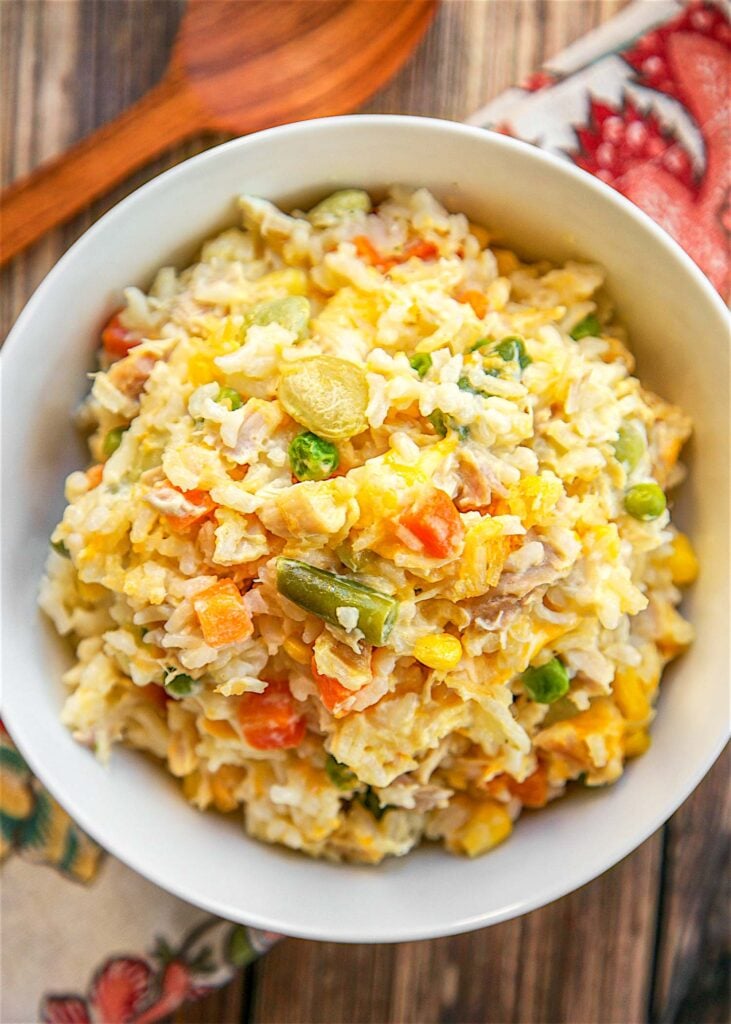 Chicken Pot Pie Rice Bake - chicken, mixed vegetables, cheddar, cream of chicken, sour cream and rice. Ready in 30 minutes! A whole meal in one pan. No need for extra sides!! We love to serve this with some buttermilk biscuits to complete the meal. Everyone loves this easy casserole dish!