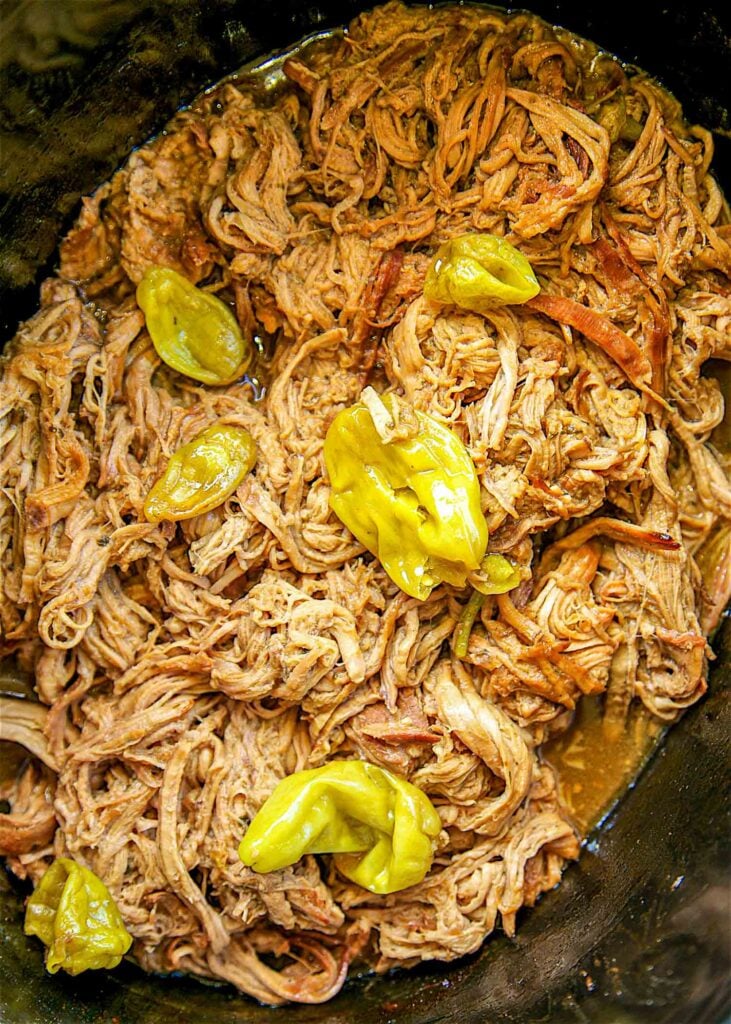 Slow Cooker Mississippi Pork Tenderloin - only 5 ingredients! Pork, Ranch, Au Jus, butter and pepperonicni peppers. This is THE BEST pork tenderloin I've ever eaten!! The flavor is AMAZING!! Serve over grits, potatoes, rice or noodles. Also great on a bun. YUM!