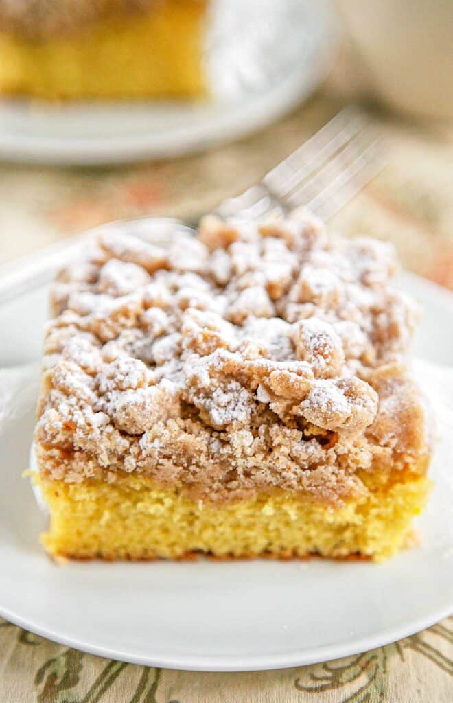 Shortcut New York Crumb Cake - yellow cake mix topped with an easy homemade crumb topping. Yellow cake mix, sugar, brown sugar, cinnamon, butter and flour. Super easy to make and tastes great. This cake is OUTRAGEOUSLY good! I could not stop eating it! Great for a crowd. We ate this for breakfast and dessert.
