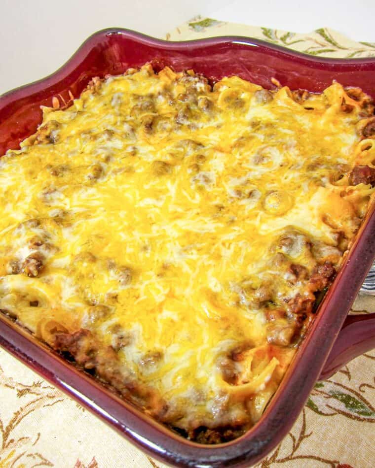 Sour Cream Noodle Bake - ready in under 30 minutes! Egg noodles, hamburger, tomato sauce, cottage cheese, sour cream and cheddar cheese. Comfort food at its best! Everyone loves this easy casserole! Can make ahead of time and refrigerate or freeze for later. YUM!