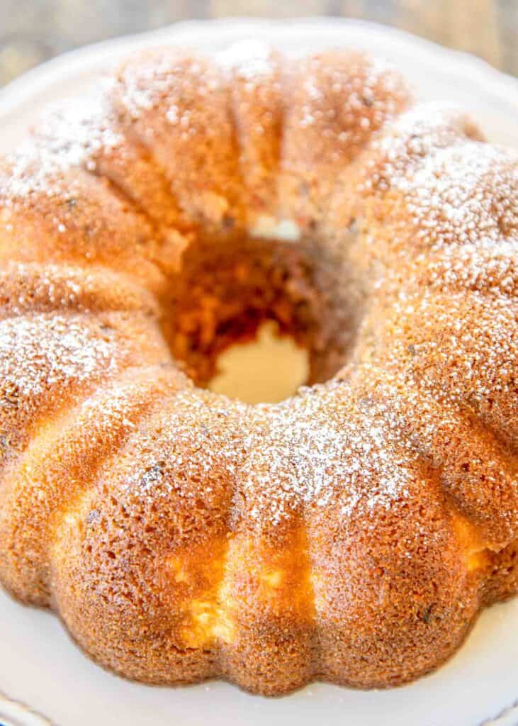Cream Cheese Carrot Bundt Cake - only a few simple ingredients make this delicious cake. Cake with a can of frosting in the batter. Carrot cake mix, water, oil, eggs, a can of coconut pecan frosting, cream cheese and sugar. I couldn't believe how delicious this cake tasted. Can make a few days in advance and store in an air-tight container. Great for holidays and potlucks! #cake #carrotcake #dessert 