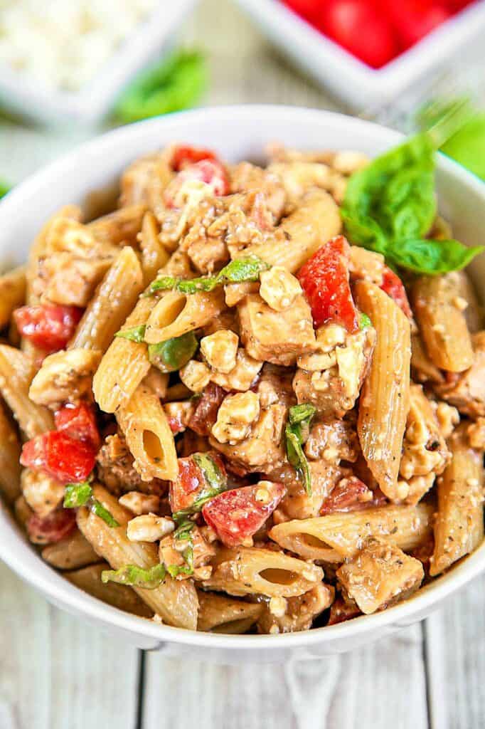 Greek Chicken Pasta Salad  - recipe for Taziki's Friday Pasta - homemade vinaigrette tossed with penne pasta, chicken, feta, tomatoes and fresh basil - good warm or cold. Great for a potluck. Can make a day ahead - the flavors get better as it sits. This is seriously delicious!