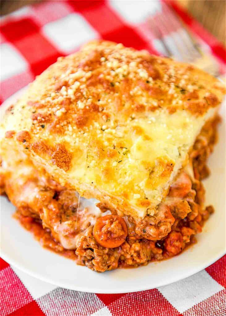 Meat Lovers Pizza Casserole - a family favorite!!! Lean ground beef, sausage, pepperoni, pasta sauce, mozzarella cheese, pizza dough and parmesan cheese. Can add your favorite veggies too! Everyone loved this! There weren't any leftovers!! YUM!