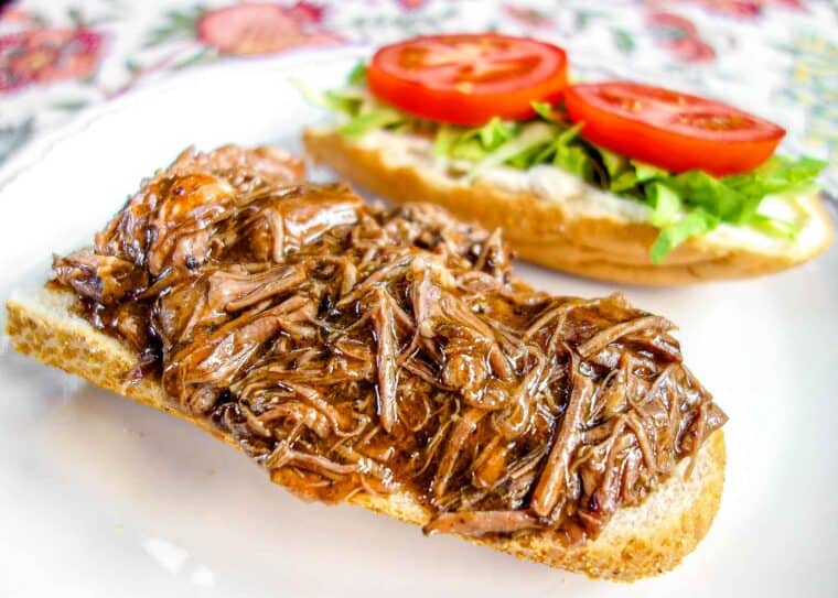 Slow Cooker New Orleans Roast Beef Po-Boy - inspired by our meal at Felix's in New Orleans. Only 5 ingredients! Slow cooked pot roast seasoned with cajun seasoning and simmered in an easy gravy. Can serve as a sandwich or over rice, noodles or mashed potatoes. This stuff is SO good!! Better than the original!