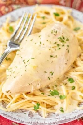 plate of chicken over pasta