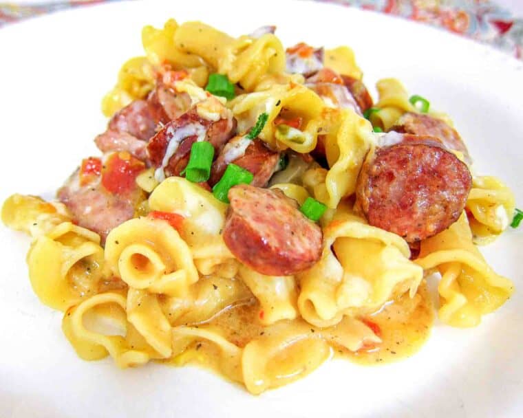 One-Pot Spicy Sausage Skillet - smoked sausage, chicken broth, cream, pasta, rotel, cheese and green onions. Everything cooks in the same skillet, even the pasta! Quick recipe! Ready in 15 minutes! My husband asked for this 3 days in a row!