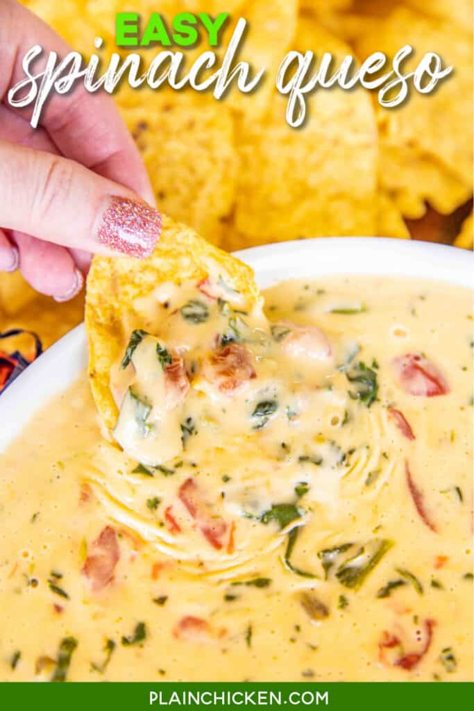 dipping chip in spinach queso