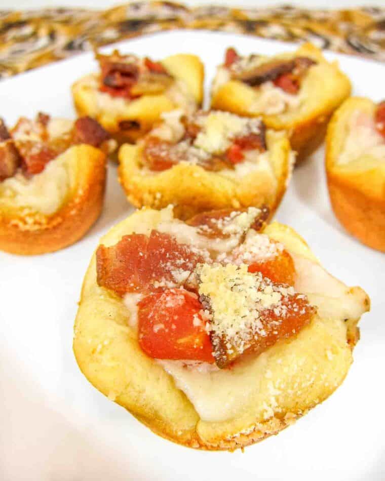 Kentucky Hot Brown Bites - turkey, bacon, tomatoes and mornay sauce baked in mini muffin pan - perfect for your Derby Day parties and leftover holiday turkey!