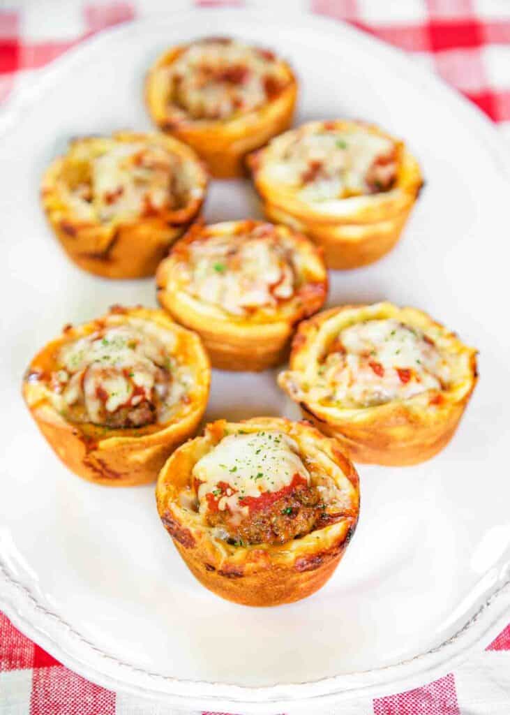 Meatball Sub Cupcakes - cream cheese, frozen meatballs, marinara and mozzarella stuffed in crescent rolls and baked in a muffin pan - SO good!! Great for lunch, dinner or a party!