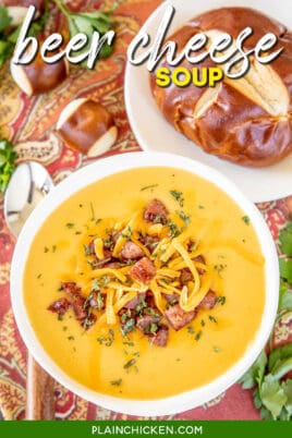 bowl of beer cheese and smoked sausage soup with a pretzel