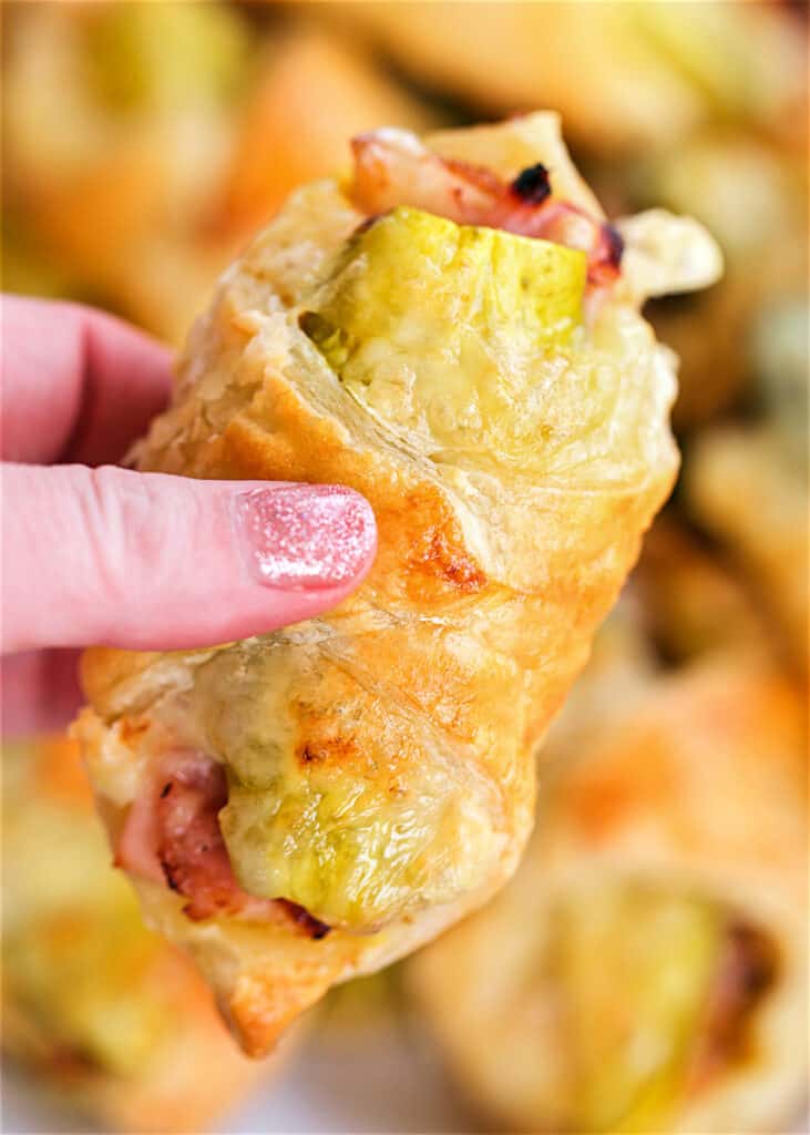 holding a turkey puff pastry sandwich
