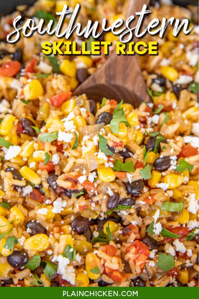 spooning rice with black beans, peppers and corn from skillet