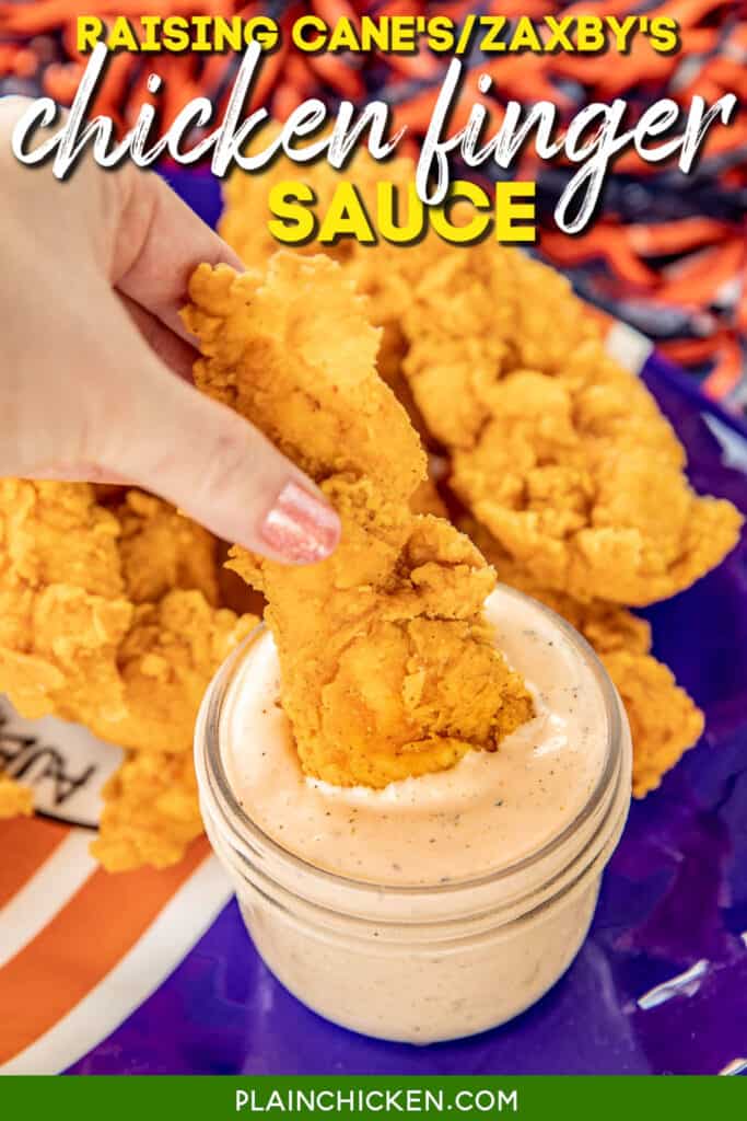 dipping fried chicken finger into a jar of chicken finger sauce