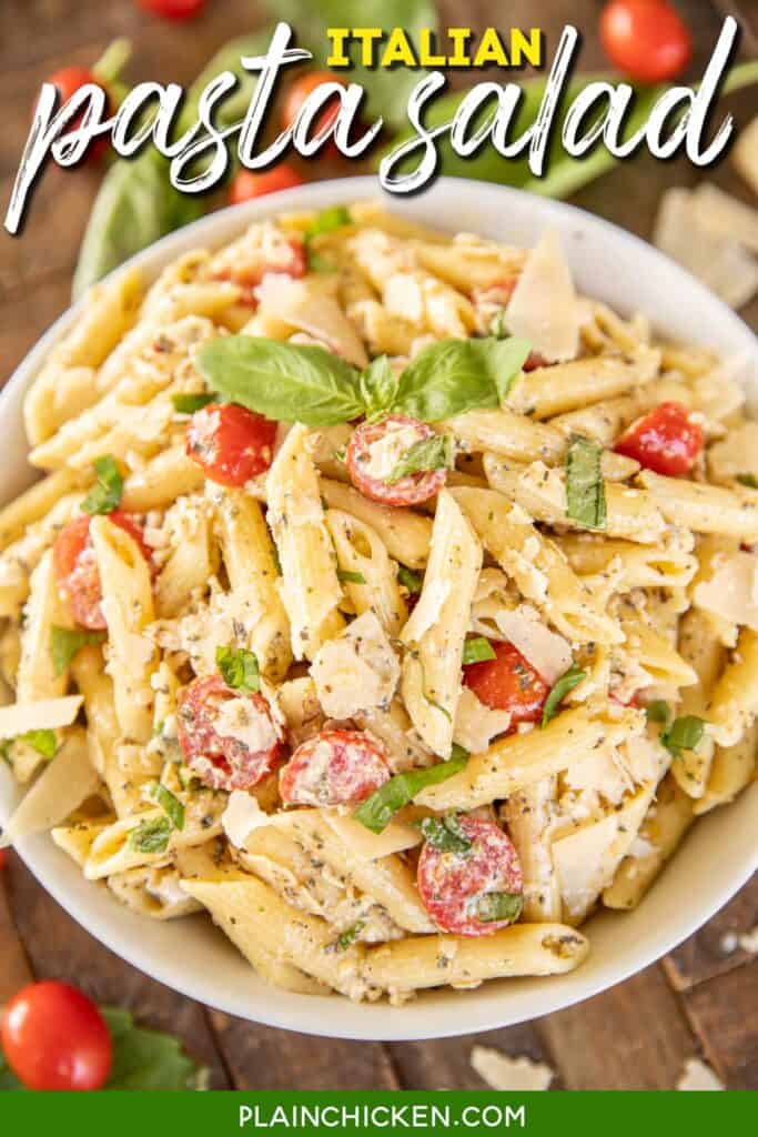 bowl of pasta salad with tomatoes parmesan and basil