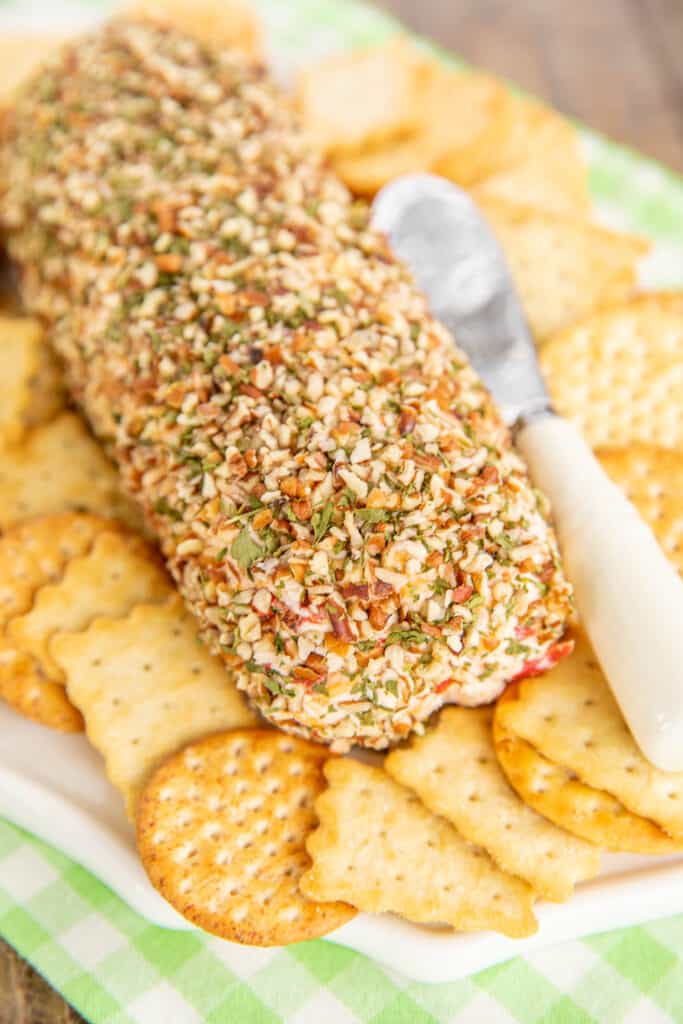 whole cheese ball rolled in chopped pecans with crackers around it