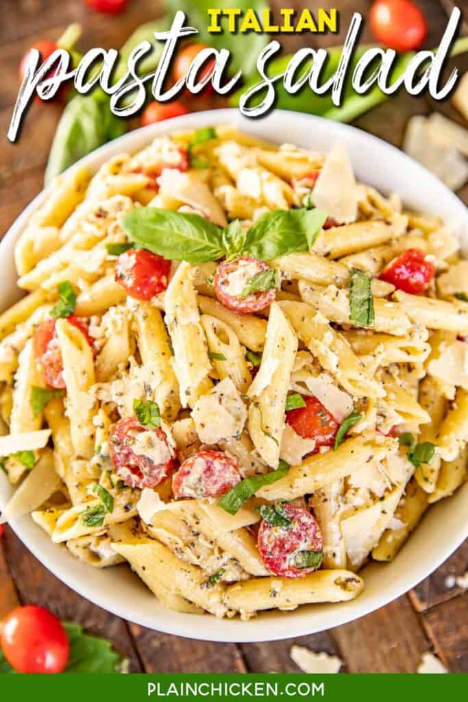 bowl of pasta salad with tomatoes parmesan and basil