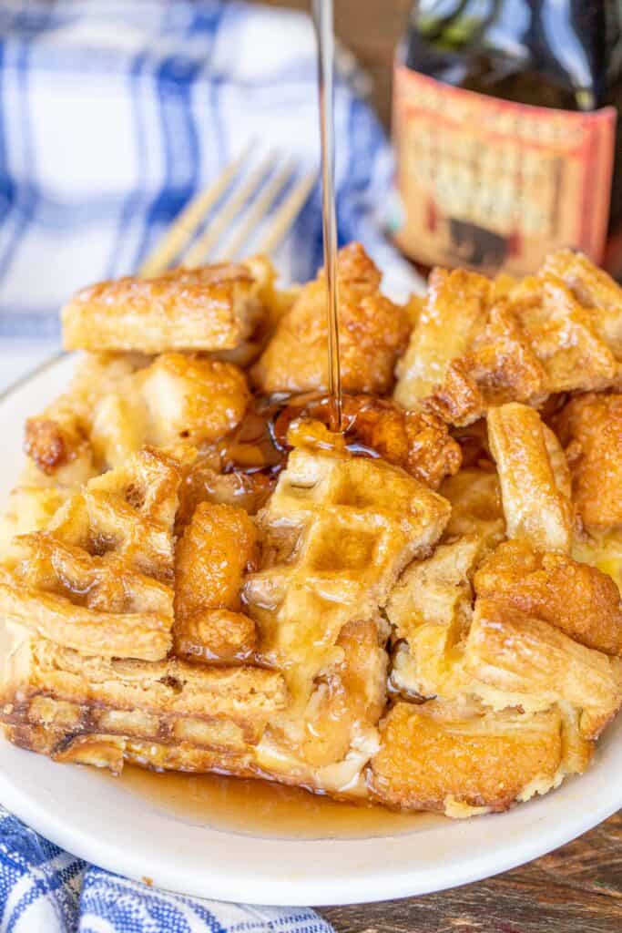 pouring syrup over chicken & waffles casserole