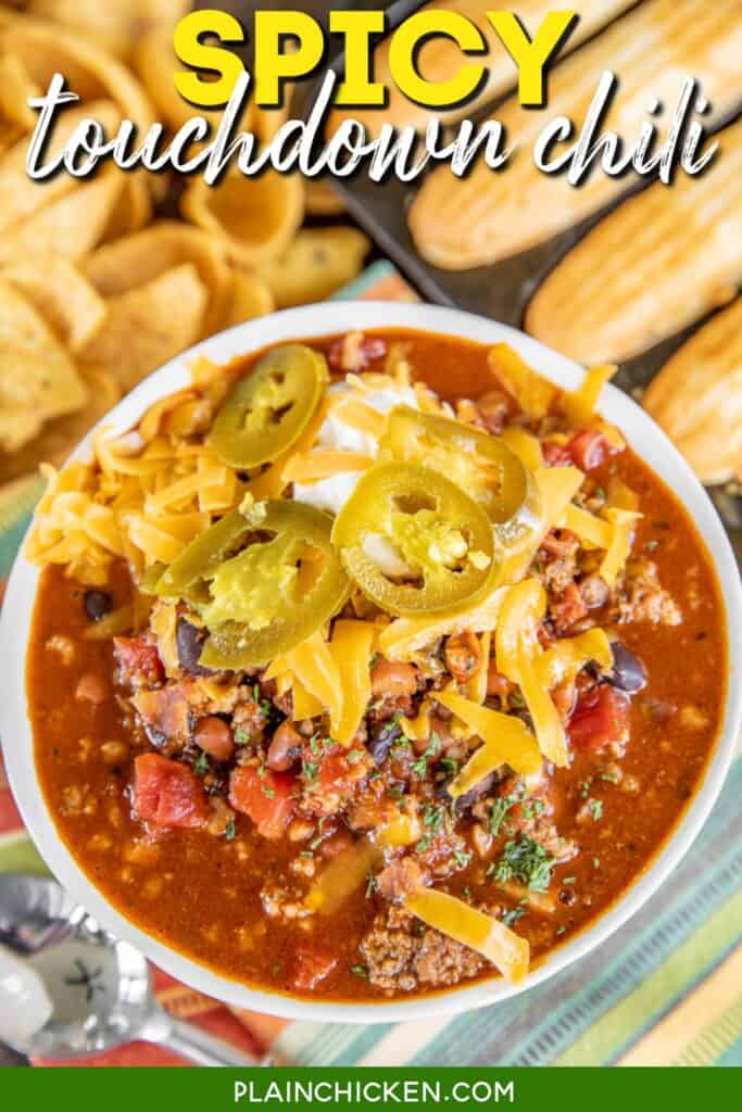 bowl of chili topped with jalapenos and cheese