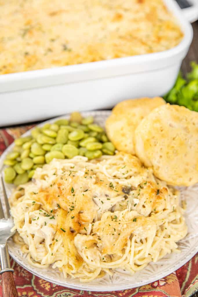 plate of chicken tetrazzini with peas and biscuits